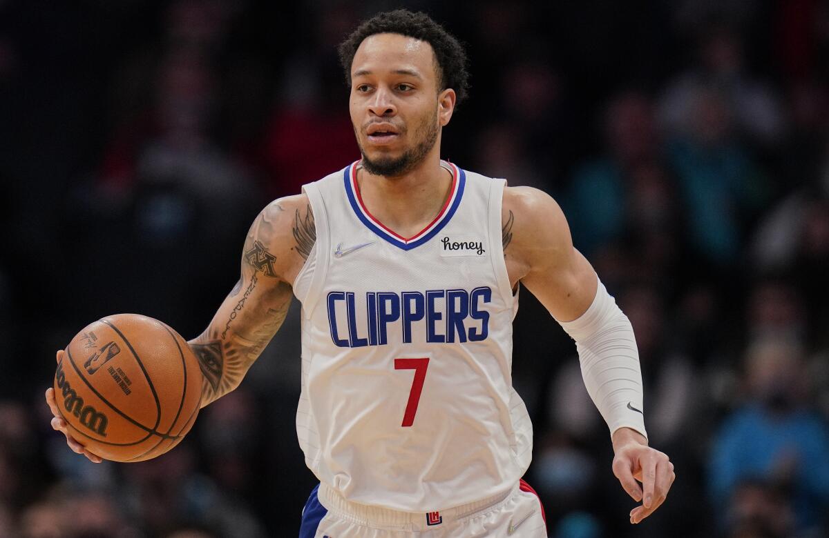 Clippers wing Amir Coffey dribbles the basketball during a game.