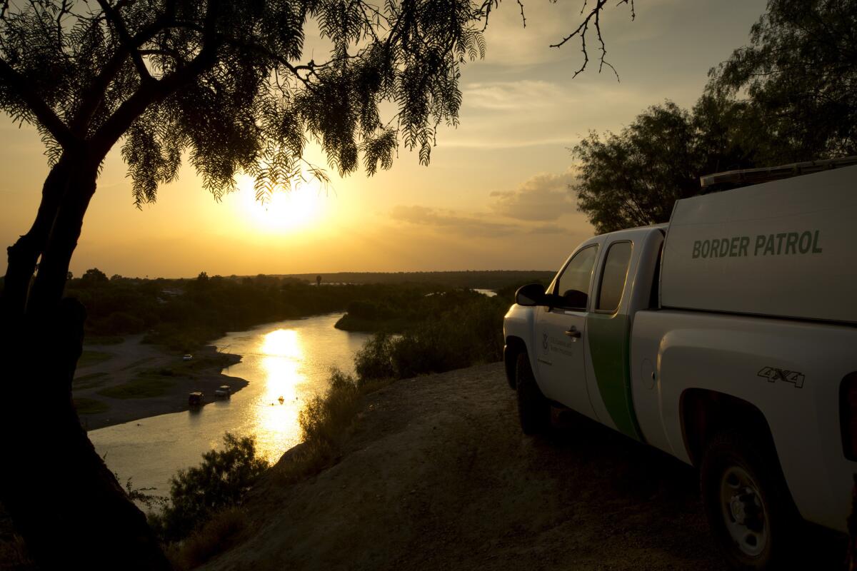 A Border Patrol agent keeps watch in Roma, Texas, across the Rio Grande. Non-government militias have also begun patrolling the border region.