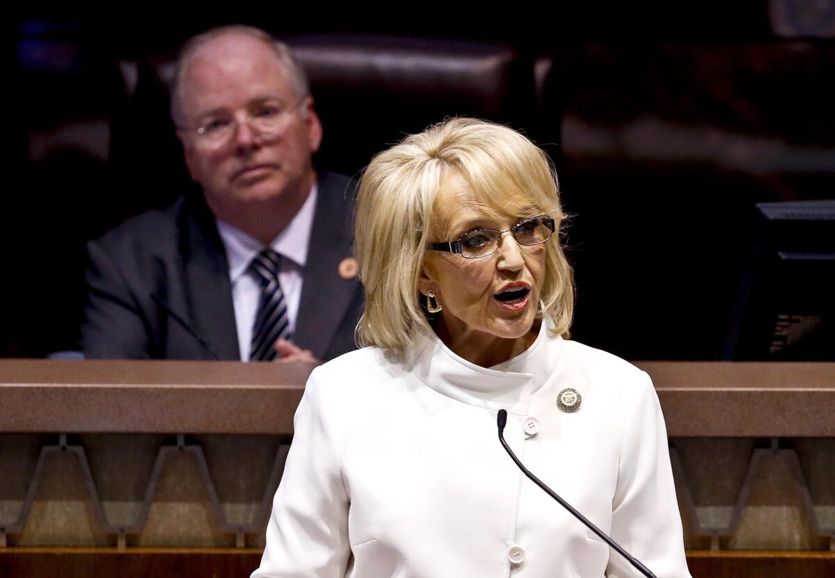 Arizona Gov. Jan Brewer is in federal court defending her 2012 executive order denying driver's licenses to young immigrants who have been granted temporary protection from deportation by the Obama administration. Above. Brewer is seen giving her State of the State address in January.