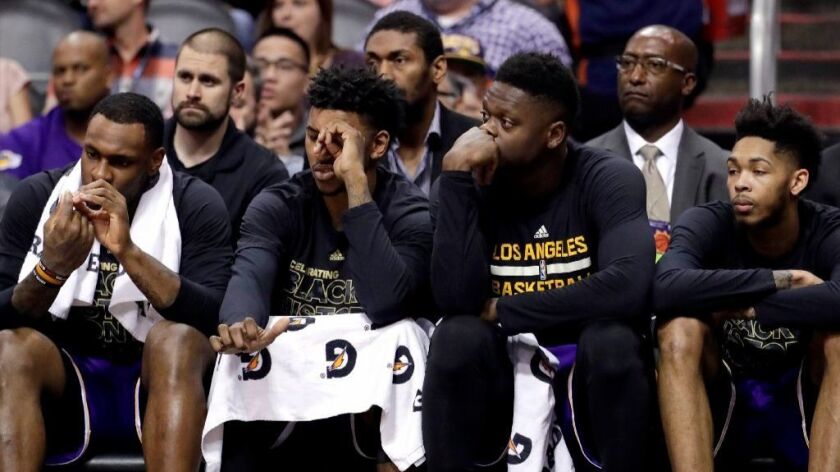 Lakers players watch from the bench during the first half of a game against the Phoenix Suns on Feb. 15.