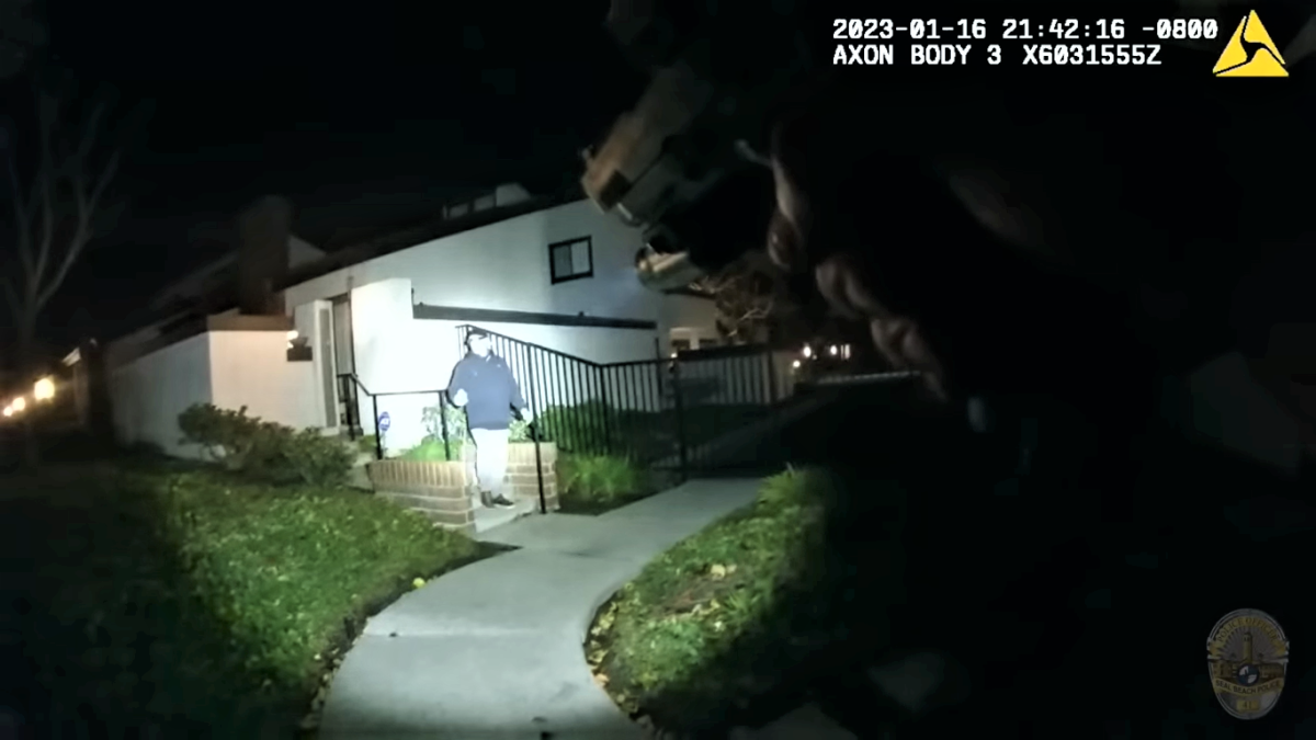 A still taken from body camera footage recorded on Jan. 17, 2023 shows a Seal Beach police officer with his gun drawn.
