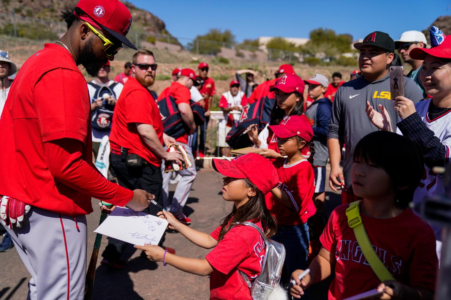 Angels prospect Jo Adell signs autographs after a spring training workout in Tempe.