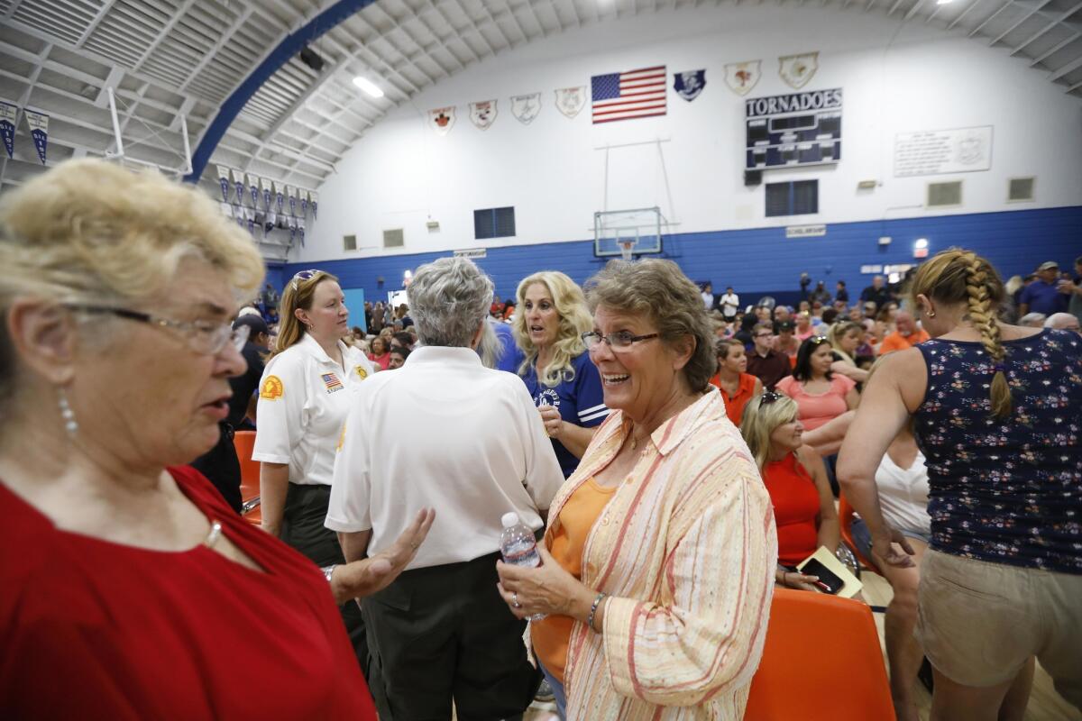 Trona residents trade earthquake stories before a community meeting Trona High School on Wednesday.