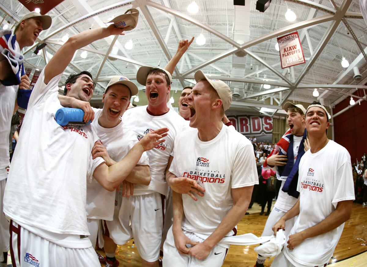 Lafayette players celebrate after defeating American 65-63 in the Patriot League tournament championship game.