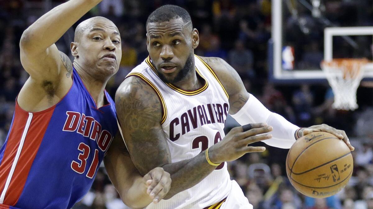 Cleveland Cavaliers' LeBron James, right, drives on Detroit Pistons' Caron Butler during a game on Monday.