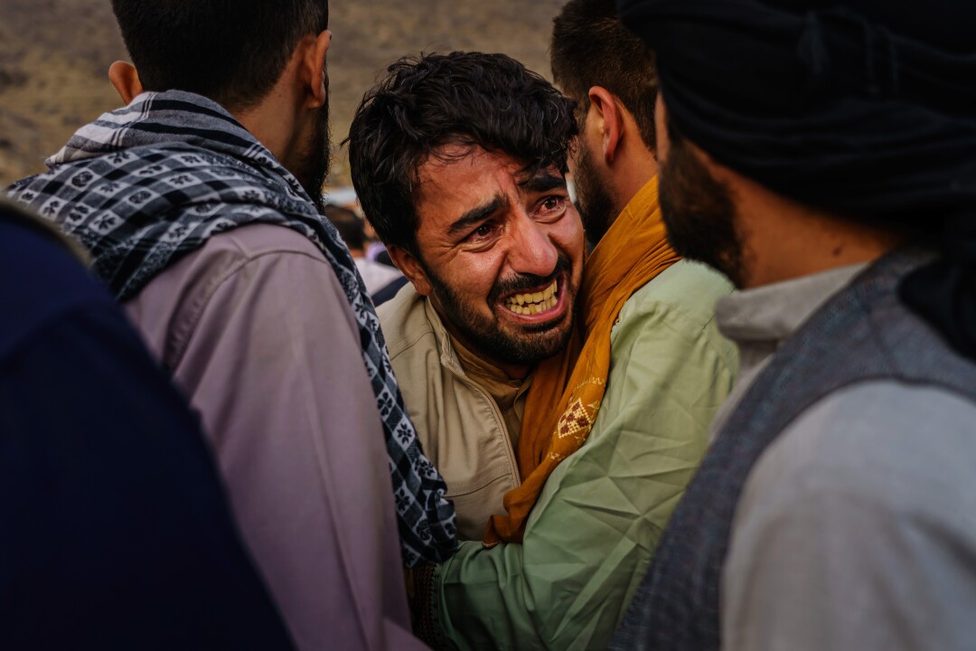 A man grieves during the mass funeral for members of the family killed in Sunday's explosion.