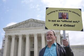 A demonstrator stands outside the Supreme Court as the justices prepare to hear arguments over whether Donald Trump is immune from prosecution in a case charging him with plotting to overturn the results of the 2020 presidential election, on Capitol Hill Thursday, April 25, 2024, in Washington. (AP Photo/Mariam Zuhaib)