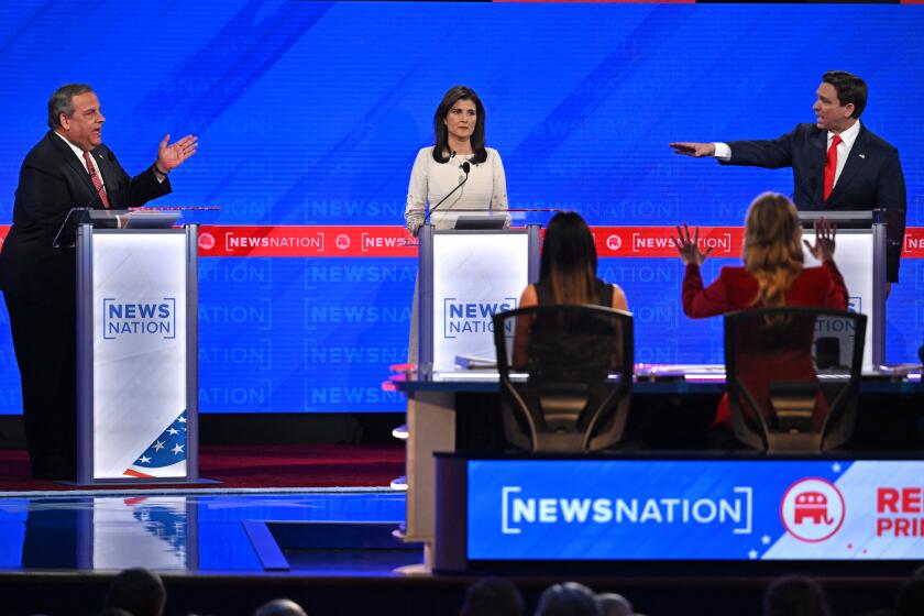 Former Governor from South Carolina and UN ambassador Nikki Haley (C) looks on as Florida Governor Ron DeSantis (R) and former Governor of New Jersey Chris Christie (L) gesture toward each other as they speak during the fourth Republican presidential primary debate at the University of Alabama in Tuscaloosa, Alabama, on December 6, 2023. (Photo by Jim WATSON / AFP) (Photo by JIM WATSON/AFP via Getty Images)