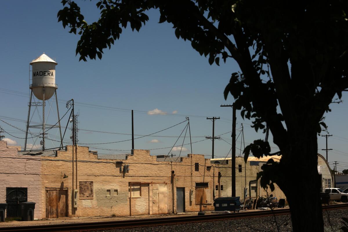A street and a wood water tower.