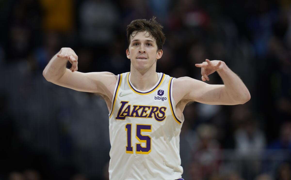 Lakers guard Austin Reaves flashes three fingers on each hand after making a three-point basket.