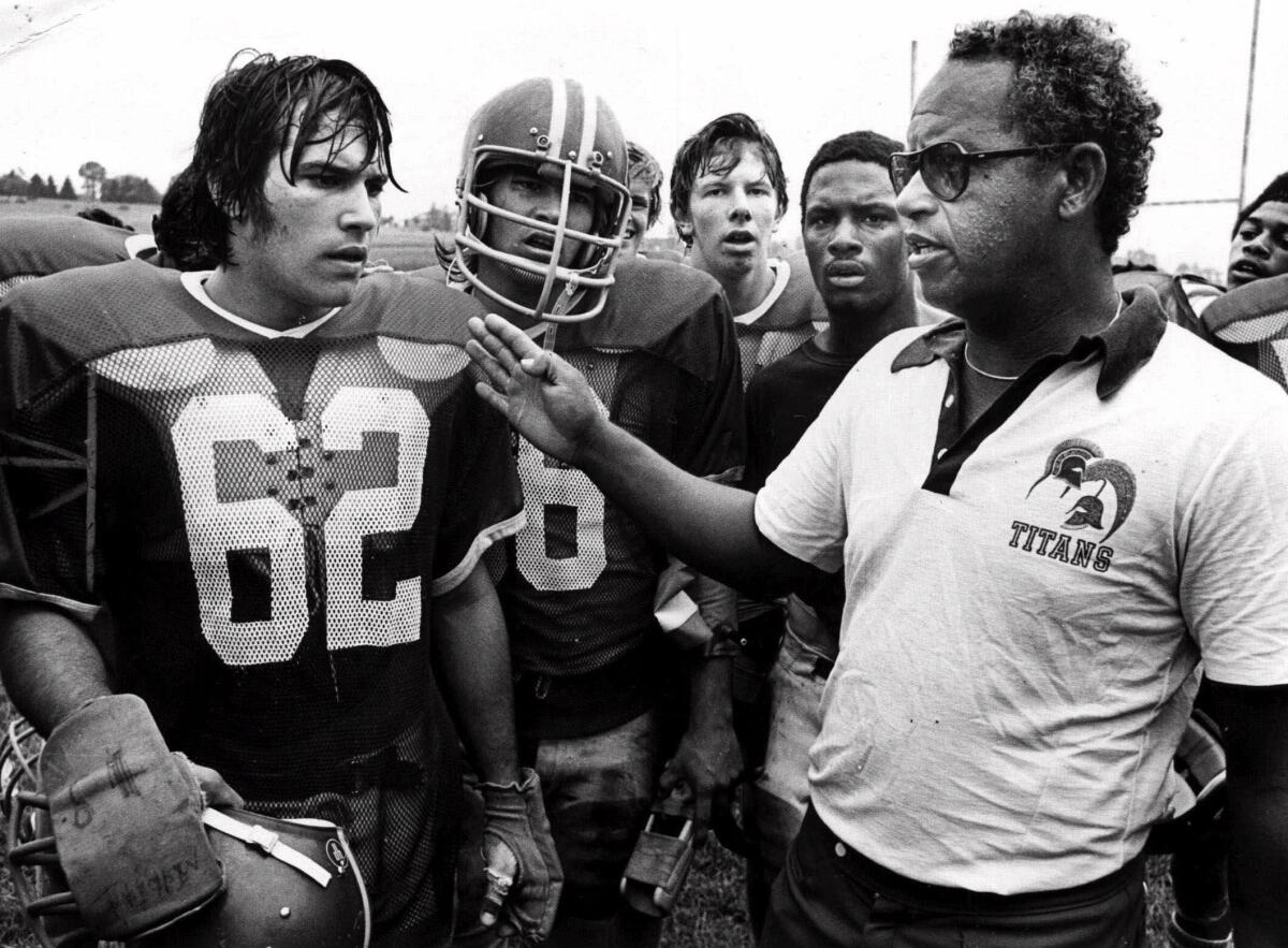 Herman Boone instructs his players at Virginia's T.C. Williams High School in the championship year of 1971. Boone, the coach who inspired the movie “Remember the Titans,” has died.