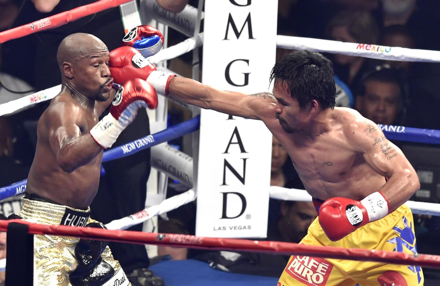 Manny Pacquiao lands a punch during the sixth round against Floyd Mayweather Jr.