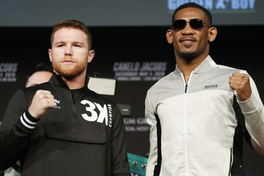 Canelo Alvarez, left, and Daniel Jacobs pose for photographers at a news conference for their middleweight title boxing match Wednesday, May 1, 2019, in Las Vegas. The two are scheduled to fight Saturday in Las Vegas. (AP Photo/John Locher)