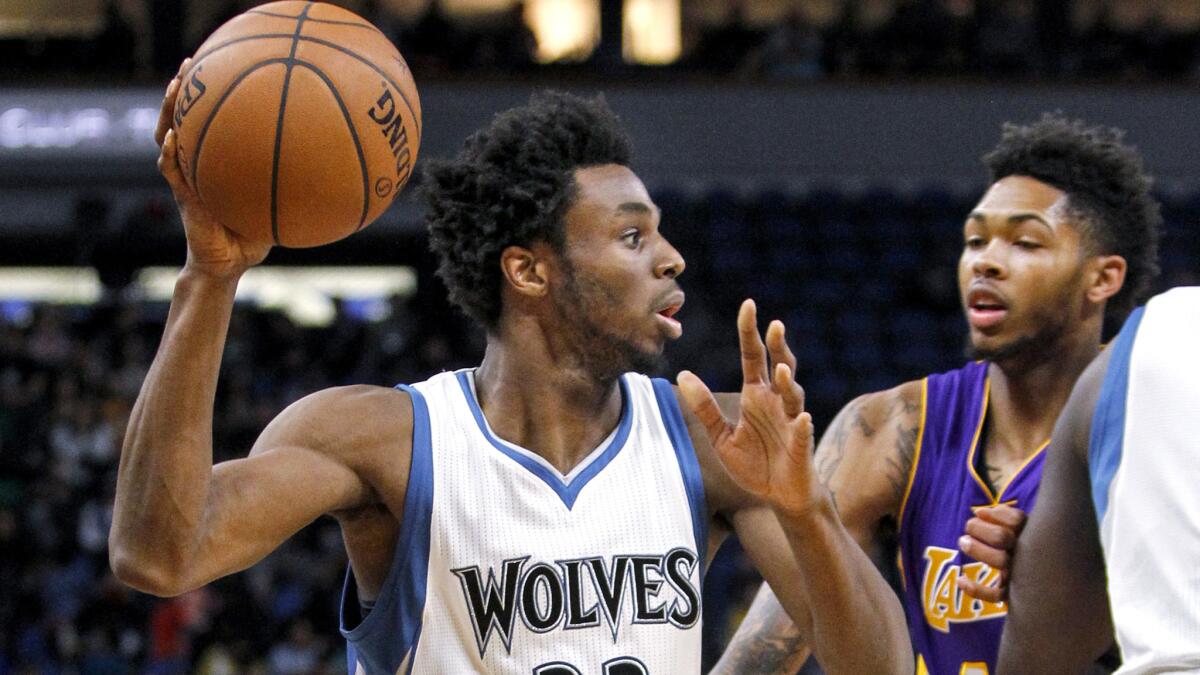 Timberwolves forward Andrew Wiggins is guarded by Lakers point guard D'Angelo Russell during their game in Minneapolis on Nov. 13.