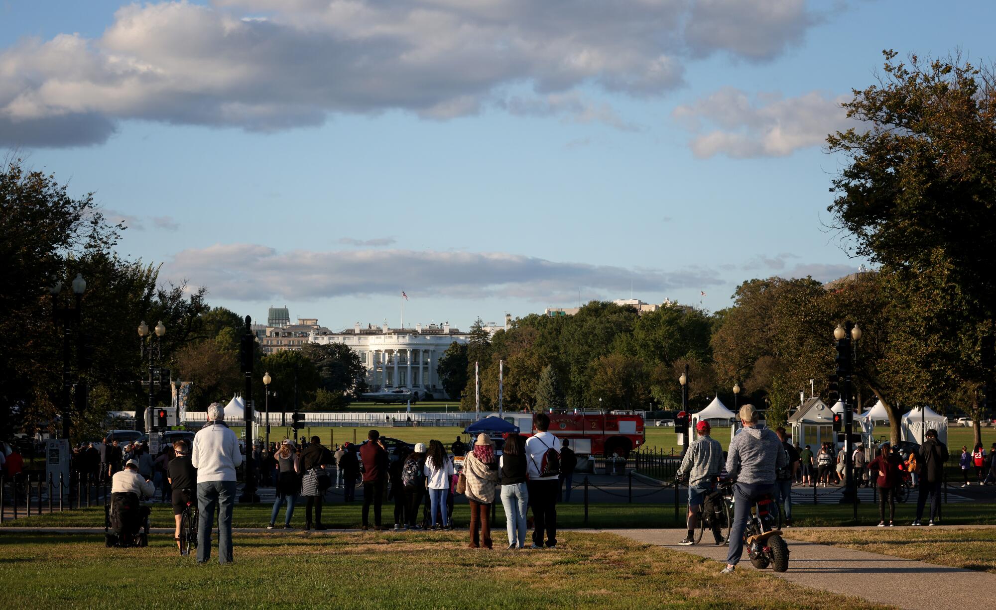 Bystanders look on as Marine One waits on the South Lawn at the White House.