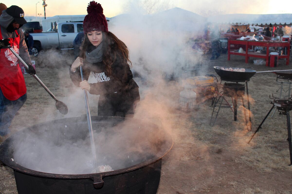 Alexis Guardian stirs chicharrones at the World's Largest Matanza, held Jan. 26 in Belen, N.M.