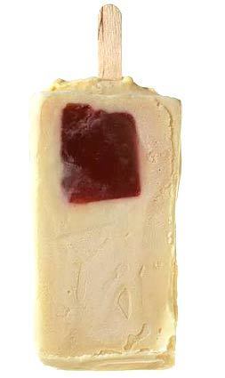A piece of guava is suspended in a paleta.