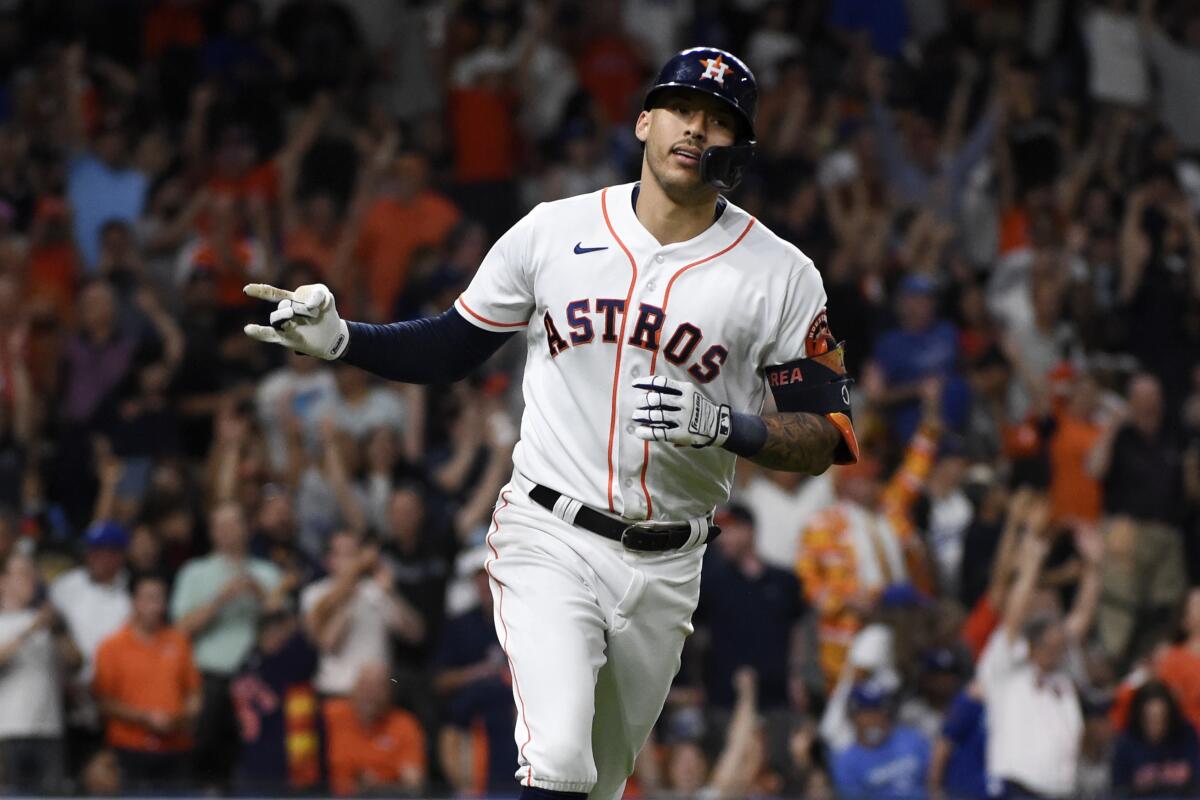 Carlos Correa rounds the bases after his home run against Trevor Bauer in the sixth inning gives the Astros a 2-1 lead .