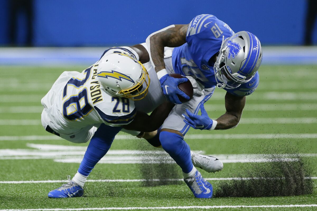Chargers defensive back Brandon Facyson (28) brings Detroit Lions wide receiver Kenny Golladay  during their game in September. 