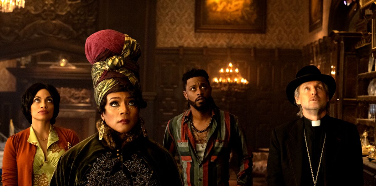 (L-R): Rosario Dawson as Gabbie, Tiffany Haddish as Harriet, LaKeith Stanfield as Ben, and Owen Wilson as Father Kent in Disney's live-action HAUNTED MANSION. Photo Jalen Marlowe.  2023 Disney Enterprises, Inc. All Rights Reserved.