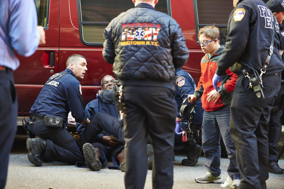Emergency responders treat victims in Lower Manhattan on Tuesday after a motorist drove onto a bike path and struck several people.
