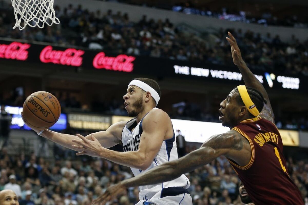 Mavericks guard Seth Curry (30) attempts a layup as Cleveland Cavaliers guard Iman Shumpert (4) defends during the second half on Jan. 30.