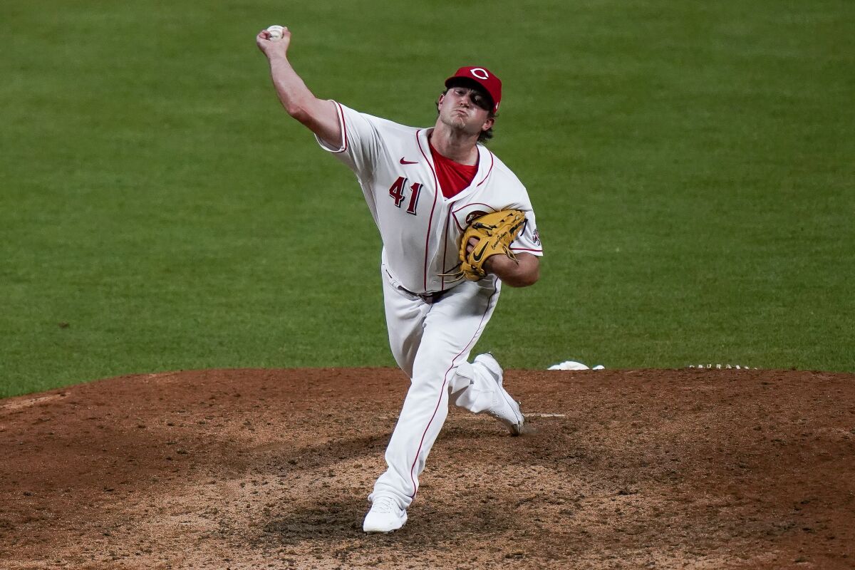 FILE - Cincinnati Reds pitcher Carson Fulmer pitches in the 9th inning of a baseball game against the Pittsburgh Pirates at Great American Ball Park in Cincinnati, Tuesday, April 6, 2021. The Los Angeles Dodgers’ Triple-A team at Oklahoma selected right-hander Carson Fulmer from Cincinnati on Wednesday, Dec. 8, 2021 with the 39th and final pick of the Triple-A phase of Major League Baseball’s annual draft of unprotected players.(AP Photo/Bryan Woolston, File)