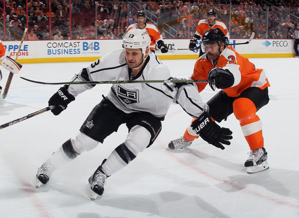 Kings forward Kyle Clifford checked by Philadelphia Flyers defenseman Radko Gudas during the first period of a game on Nov. 17.