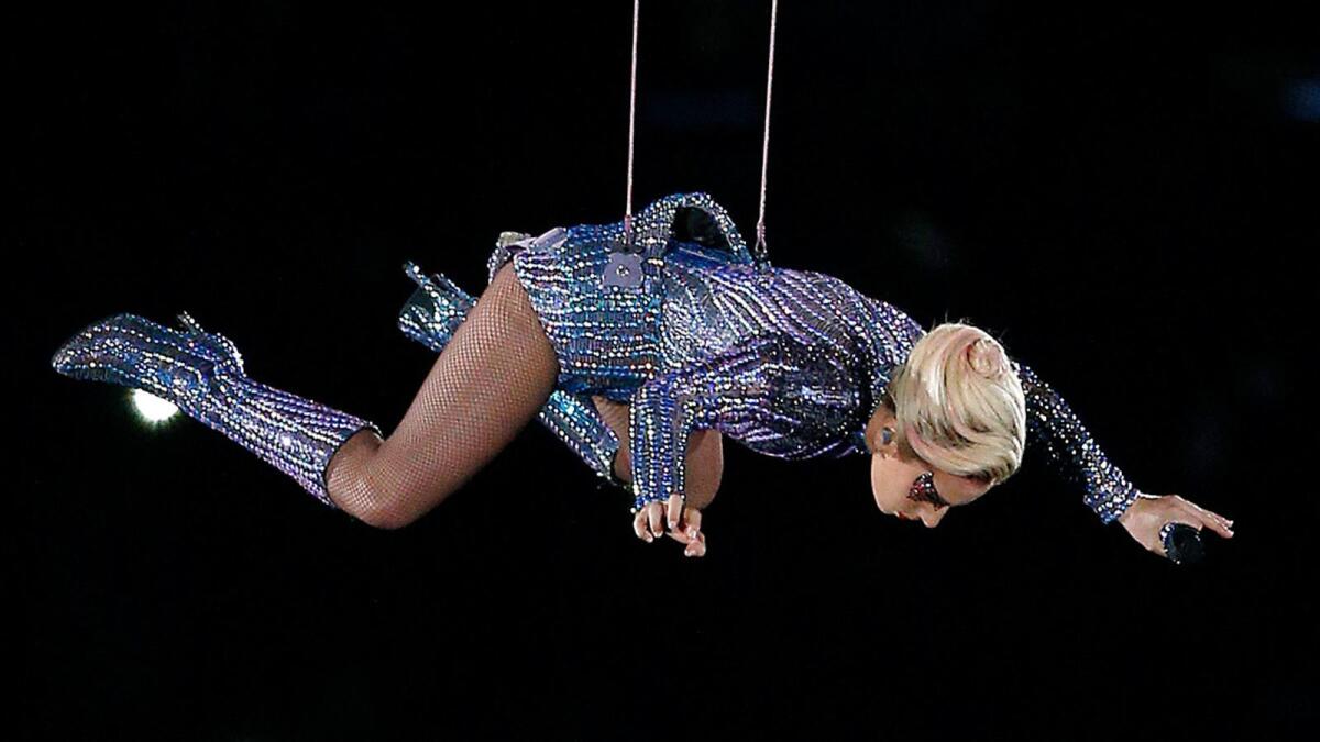 Lady Gaga descends from in high on NRG Stadium on Sunday as part of the Super Bowl halftime show.