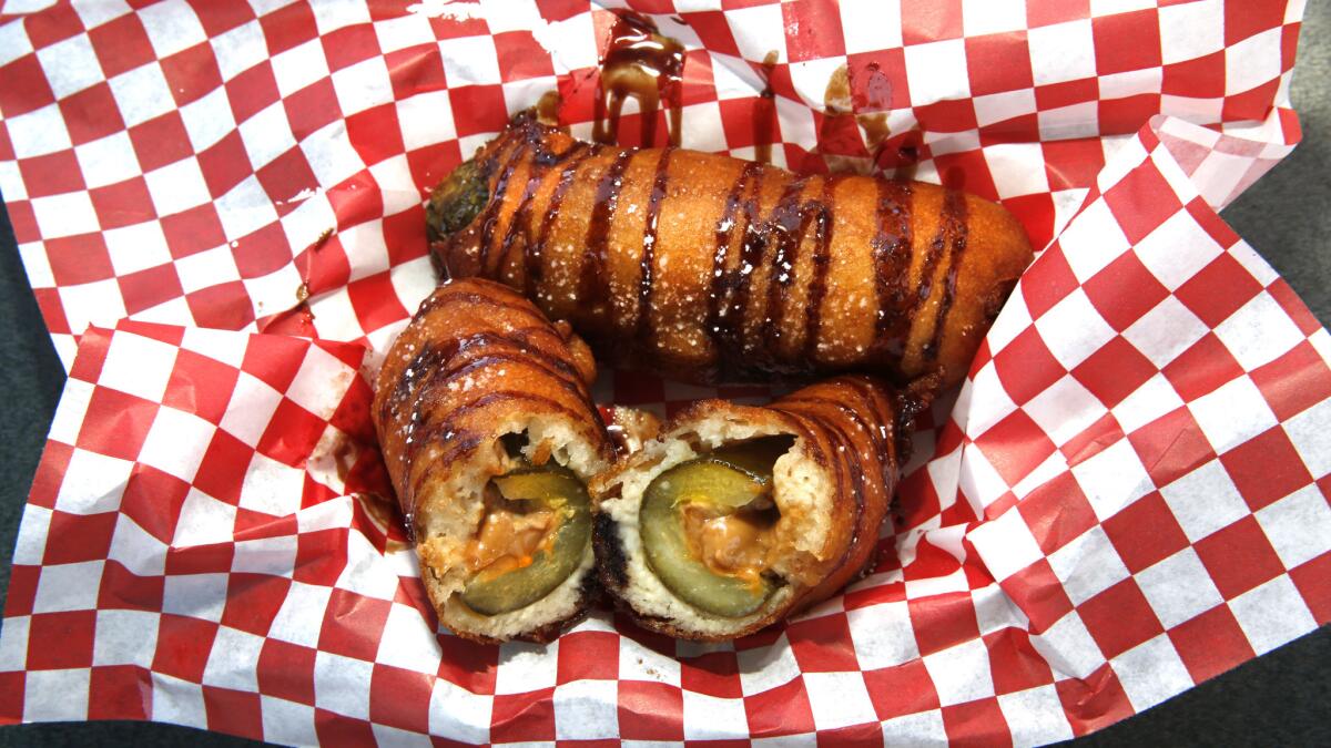 Deep-fried peanut butter stuffed pickle. Dill pickle stuffed with peanut butter, wrapped in dough and deep fried. $6.75 from Chicken Charlie's at the 2015 Orange County Fair. (Don Bartletti / Los Angeles Times)