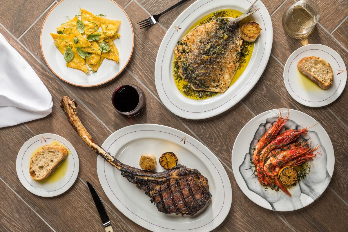 Among the dishes at Ambra Italian Kitchen + Bar are tomahawk ribeye steak, ravioli with ricotta and fennel pollen, wild Spanish carbineros shrimp served scampi-style and whole, wood-fire grilled branzino.