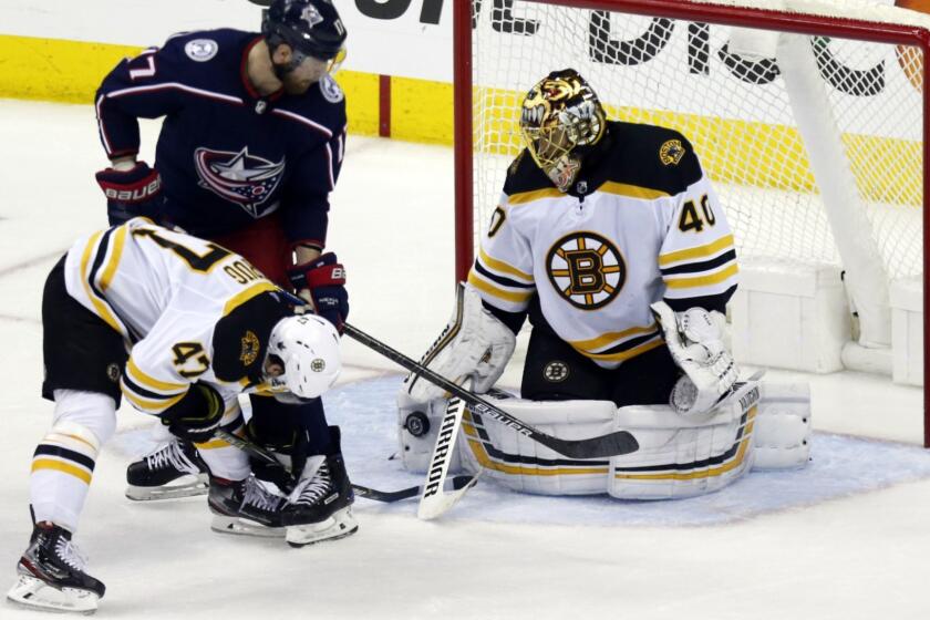 Boston Bruins goalie Tuukka Rask, right, of Finland, stops a shot by Columbus Blue Jackets forward Brandon Dubinsky, as Bruins defenseman Torey Krug helps Rask during the third period of Game 4 of an NHL hockey second-round playoff series in Columbus, Ohio, Thursday, May 2, 2019. The Bruins won 4-1. (AP Photo/Paul Vernon)