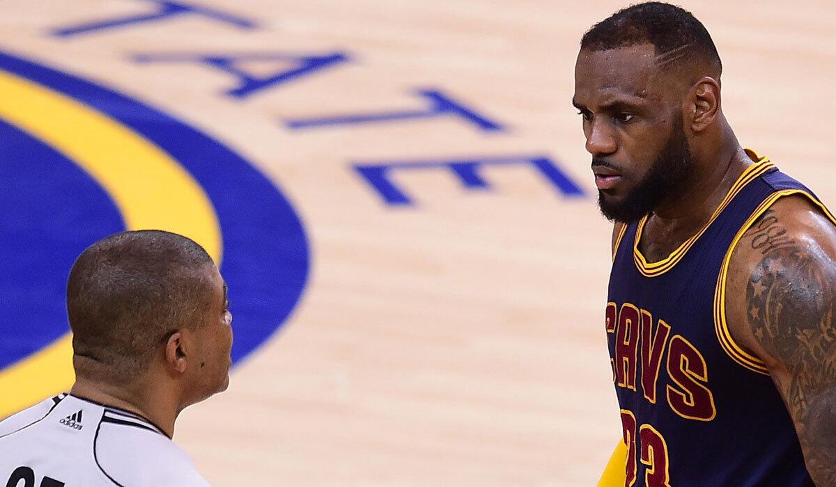 Cleveland's LeBron James confers with the referee during Game 2 of the NBA Finals against Golden State on Sunday.