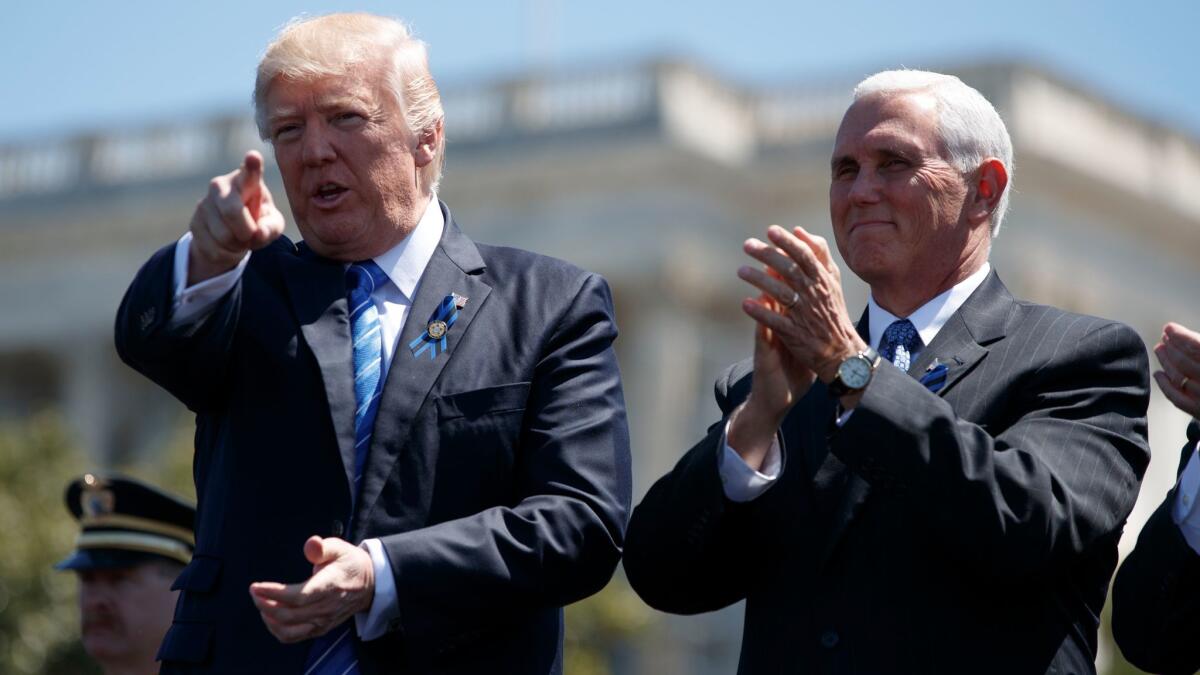 President Donald Trump stands with Vice President Mike Pence during the 36th annual National Peace Officers Memorial Service on May 15 in Washington.