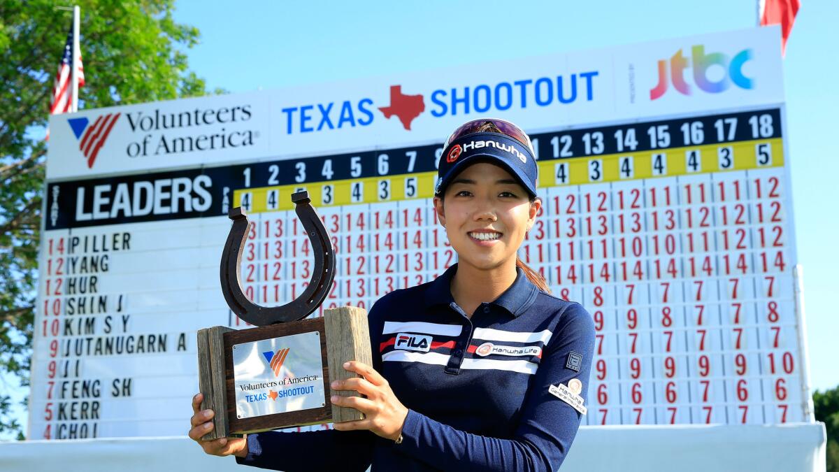 Jenny Shin poses with the winner's trophy Sunday after her two-stroke victory at the Volunteers of America Texas Shootout.