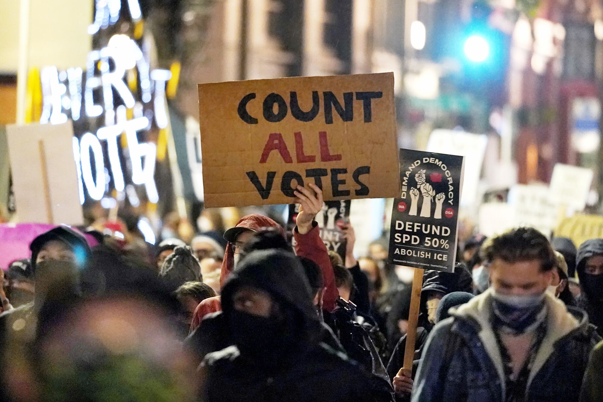 Protesters representing Black Lives Matter and Protect the Results march Wednesday evening in Seattle.
