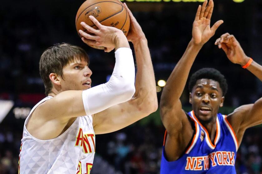 Hawks guard Kyle Korver lines up a shot as Knicks guard Justin Holiday arrives late on the close out during a game Dec. 28.