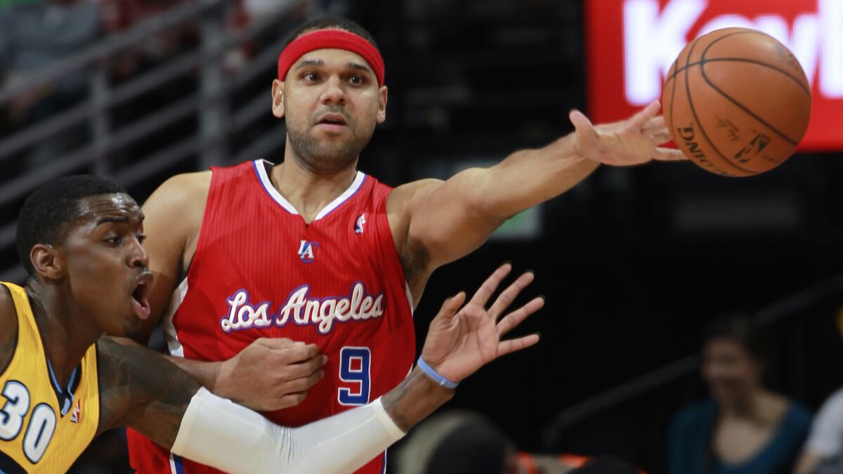 Clippers forward Jared Dudley, right, passes ball as Denver Nuggets forward Quincy Miller during a game in February. The Clippers traded Dudley to the Milwaukee Bucks on Tuesday.