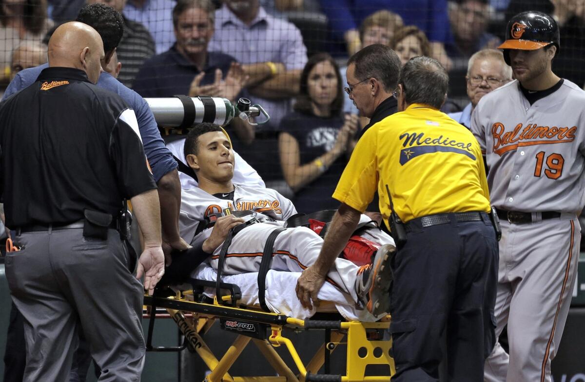 Baltimore Orioles third baseman Manny Machado is taken off the field by medical personnel after injuring his left leg on a single during Monday's game against the Tampa Bay Rays.