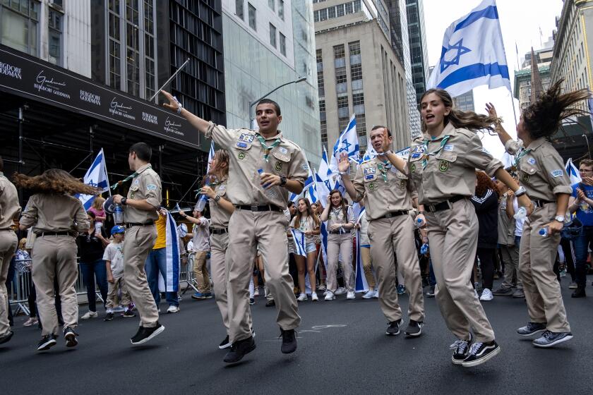 FILE - Participants dance as they take part in the Celebrate Israel Parade Sunday, June 2, 2019, in New York. A New York City parade for Israel that annually draws masses of people will step off Sunday with tight security and a stress on solidarity amid the war in Gaza. (AP Photo/Craig Ruttle, file)