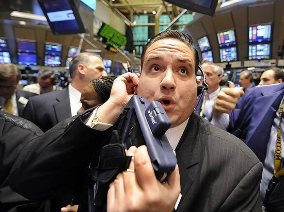 Trader Tom Kalikas works on the floor of the New York Stock Exchange. Wall Street tumbled again today, joining a sell-off around the world as fears grew that the financial crisis will affect economies globally despite bailout efforts by the U.S. and other governments.