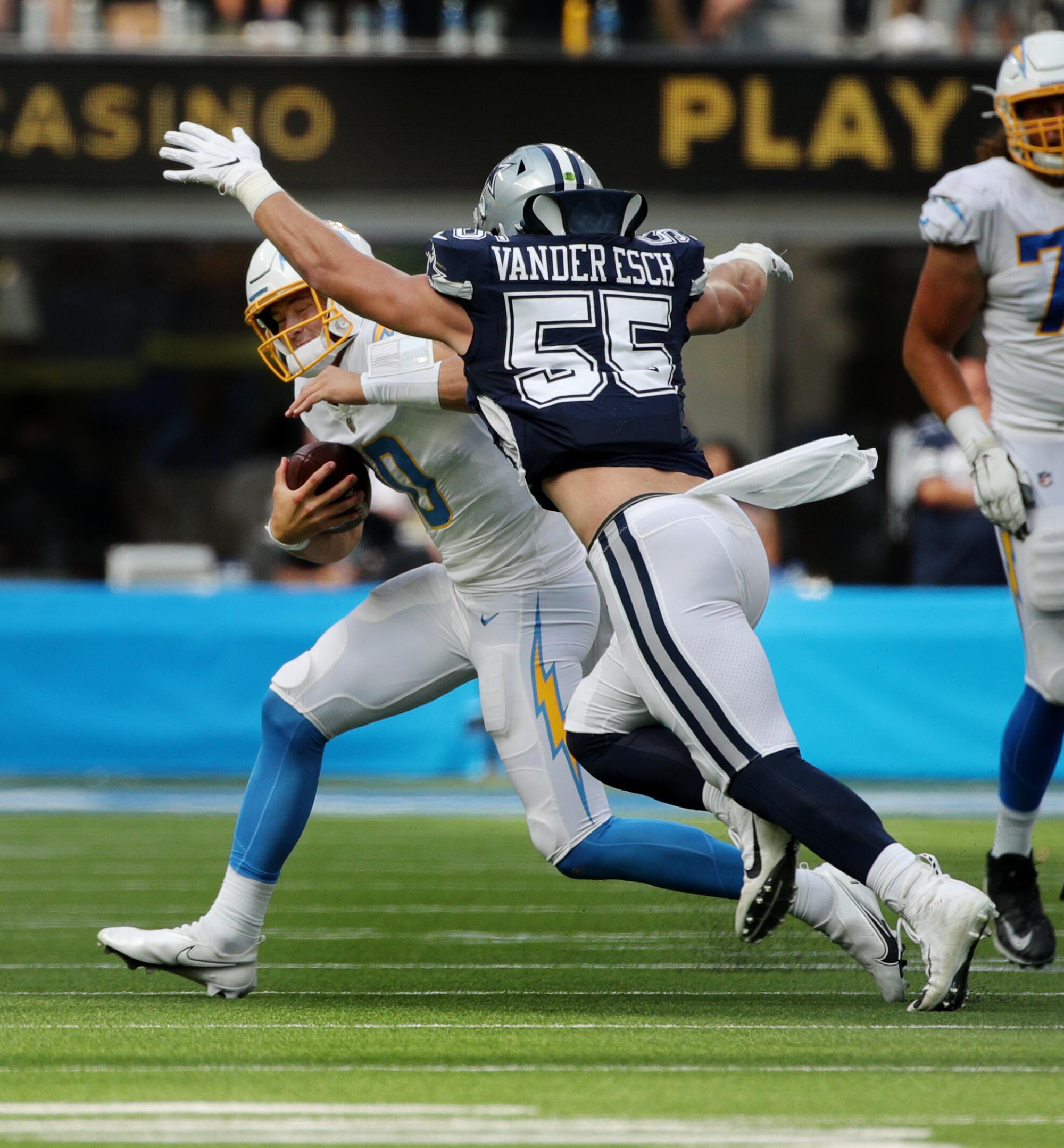Chargers quarterback Justin Herbert is chased and sacked by Dallas Cowboys outside linebacker Leighton Vander Esch.