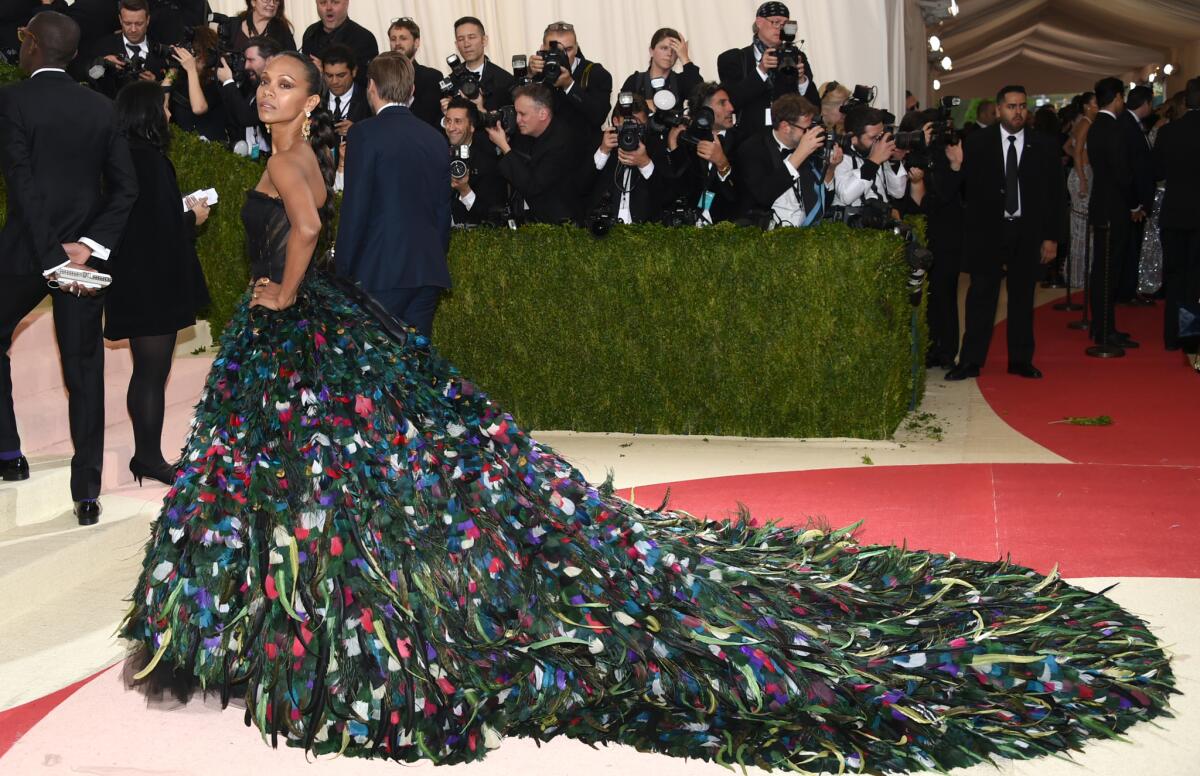 Zoe Saldana poses on the red carpet at the Met Gala.