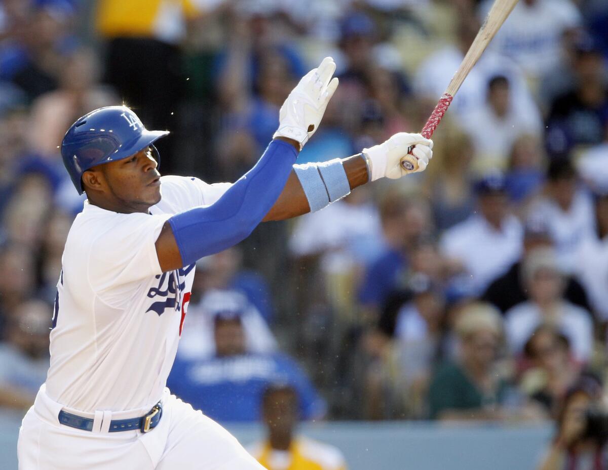 Yasiel Puig hits a two-run single against the San Francisco Giants on Sunday. A ruptured callus has forced him out of Thursday's game against the Chicago Cubs.