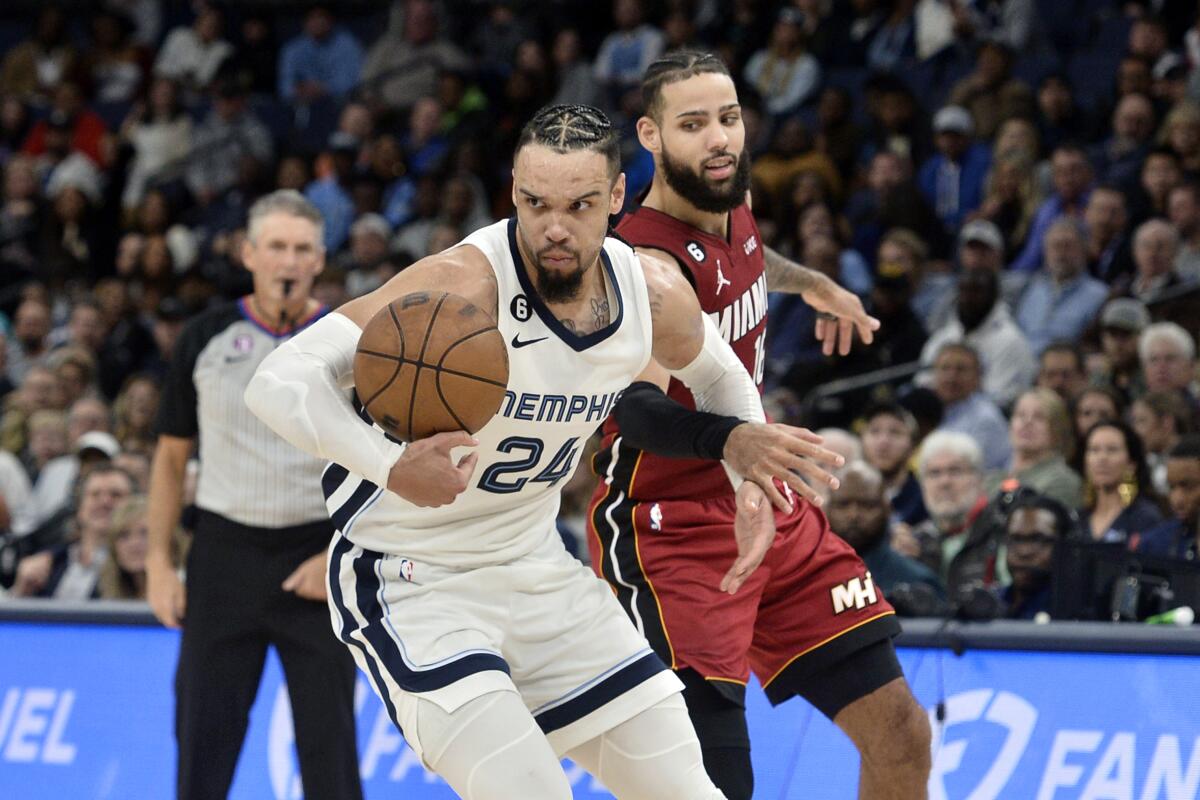 Memphis Grizzlies forward Dillon Brooks (24) handles the ball ahead of Miami Heat forward Caleb Martin in the second half of an NBA basketball game, Monday, Dec. 5, 2022, in Memphis, Tenn. (AP Photo/Brandon Dill)