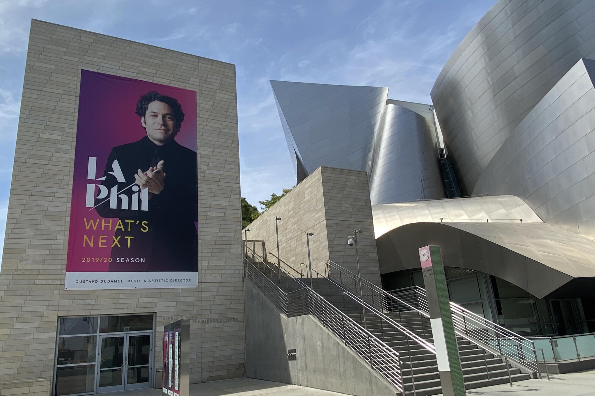 An L.A. Phil poster depicting Gustavo Dudamel is displayed outside the Walt Disney Concert Hall