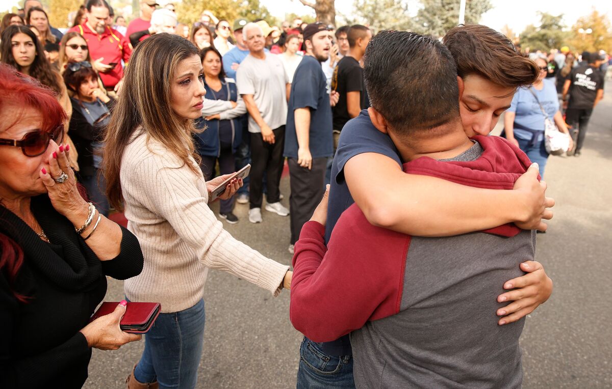Saugus High School student Dylan Reynoso hugs his father