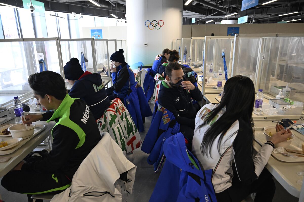 FILE - Athletes eat a meal in a restaurant at the Olympic Village ahead of the 2022 Winter Olympics, Feb. 1, 2022, in Beijing. (Wang Zhao/Pool Photo via AP, File)