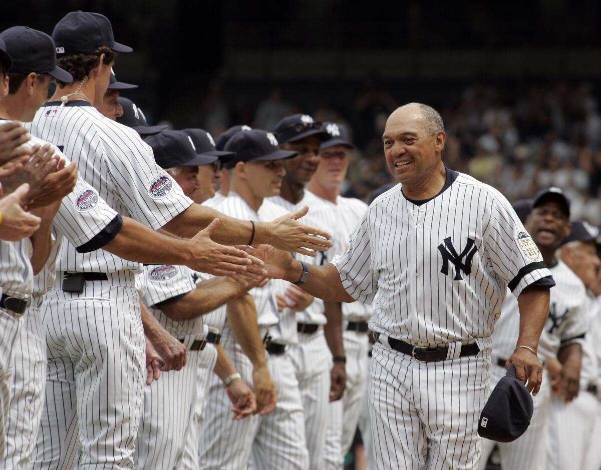 Former Yankees player Reggie Jackson greets other ex-players before an old-timers game at Yankee Stadium