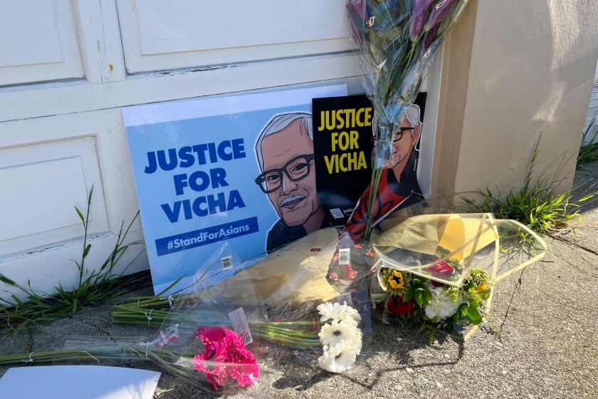 FILE - Flowers are left with pictures of 84-year-old Vicha Ratanapakdee during a rally attended by hundreds of people on Jan. 30, 2022, in San Francisco. A street in San Francisco will be renamed Saturday, Oct. 1, 2022, in honor of the 84-year-old Thai grandfather killed in a brutal attack that galvanized Asian Americans reeling from a surge in assaults during the pandemic. (AP Photo/Janie Har, File)